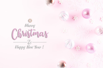 Christmas background concept. Top view of Christmas ball with snowflakes on light pink pastel background.