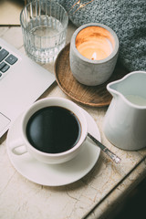 Cozy freelancer's winter work place at home with cup of coffee