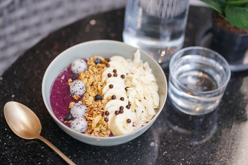 Acai berry. Acai berry smoothy for breakfast with granular and fresh fruits such as blueberries and dragon fruits.