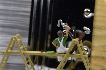 tiny painters are painting. Standing on a ladder, walking around brushes