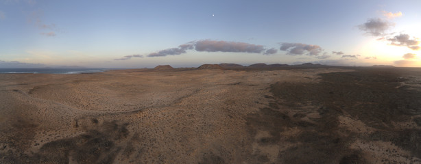 Fototapeta na wymiar Fuerteventura desert landscape with volcano and sunrise