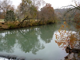 Scenic view of War Eagle river with colorful trees reflected in the waters in autumn.
