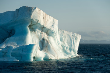 A large iceberg drifts at sea in Arctic Ocean having detached from a glacier.Climate Crisis.Image