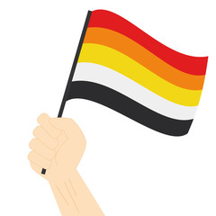 Hand holding and raising Lithsexual pride flag isolated on white background