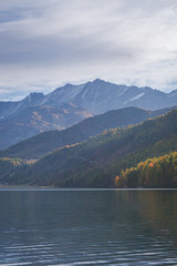 The Sils lake, the forest, the nature and the alps near the village of Maloja, Engadin, Switzerland - October 2019.