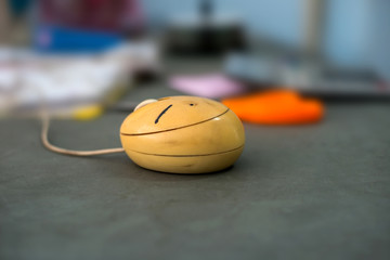 Old dirty mouse for computer on blurred office background,photo soft focus.