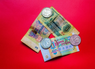 Composition of paper and metal rubles of the USSR on a red background. Close-up.