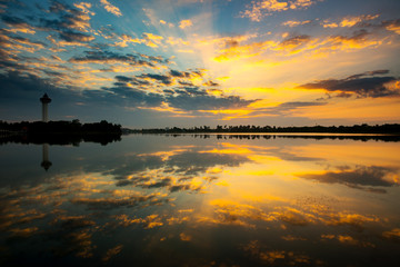 Panorama silhouette tree in africa with sunset.Tree silhouetted against a setting sun reflection on water.Typical african sunset with acacia trees in Masai Mara, Kenya.
