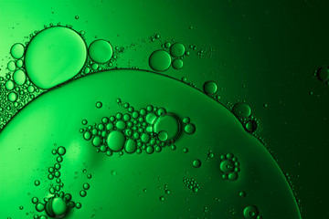 abstract science background, backlit green liquid biology or chemistry themed macro photograph