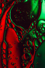 colorful dark red and green abstract liquid background, macro photograph
