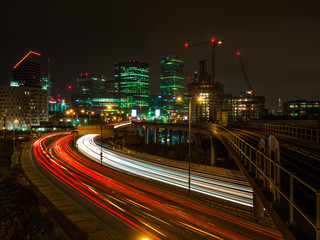Light trails and urban view from East India towards Canary Wharf in London stock photo
