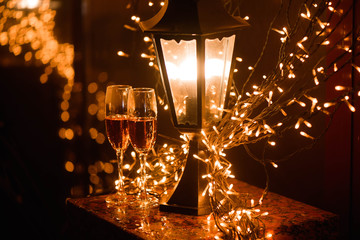Two glasses of champagne over blur spots lights background. Celebration, free space for text