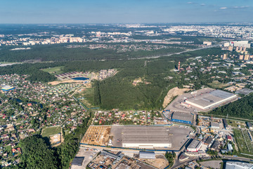 The outskirts of a big city. Aerial view, sunny summer day.