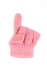 Pointing gesture on a white background. Children's woolen glove isolated.