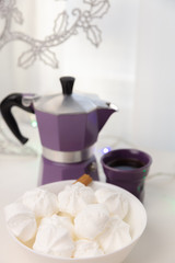 Fototapeta na wymiar Coffee mug, coffee pot, lanterns, marshmallows on a wooden window sill