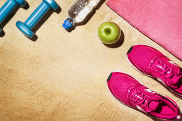 Top view beach and fitness accessories. Background with copy space