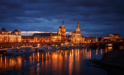 Awesome colorful scene during sunset  at the Old Town in Dresden, Saxony, Germany. Famouse Sights: Frauenkirche, Hofkirche, Semperoper with reflected in calm water Elbe river.  Postcard