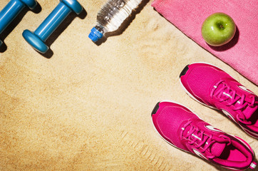 Top view beach and fitness accessories. Background with copy space