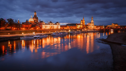 Fototapeta na wymiar Awesome colorful scene during sunset at the Old Town in Dresden, Saxony, Germany. Famouse Sights: Frauenkirche, Hofkirche, Semperoper with reflected in calm water Elbe river. picturesque scenery.