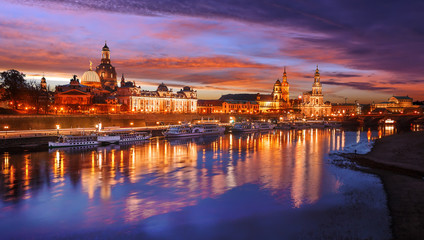 Fototapeta na wymiar Awesome colorful scene during sunset at the Old Town in Dresden, Saxony, Germany. Famouse Sights: Frauenkirche, Hofkirche, Semperoper with reflected in calm water Elbe river. Postcard