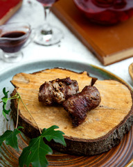 crispy pieces of fried meat on a wooden hemp