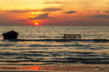 Silhouette of  Fishing boat and Fishing equipment. Sunset and Fishing boat at Sea rayong,Thailand.