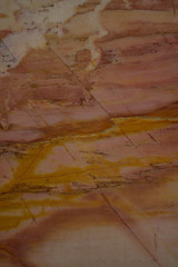 Pink marble onyx. Vertical image. Warm pink-yellow shades. Beautiful background close-up