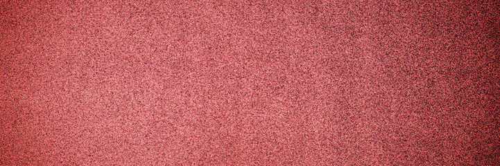 Christmas rose gold background. Red paper background. Metallic glitter noise red background, close up. 