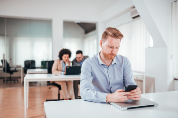 Redhead man in office doing his work.