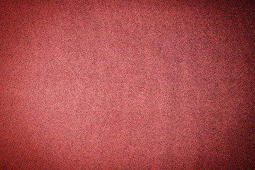 Christmas rose gold background. Red paper background. Metallic glitter grain red background