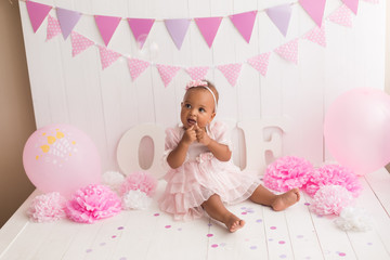 little girl black on white background. baby's first birthday