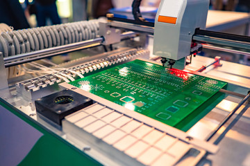 PCB. Machine for the production of computer boards. Electronic chips. Machine creates a chip. Processor manufacturing. Chip manufacturing machine. High precision equipment. PCB manufacturing. - obrazy, fototapety, plakaty