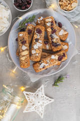 Granola bar. Healthy snack. Cereal granola bar with nuts, fruit, coconut and cranberries on a christmas table. Top view