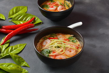 Laksa Soup – a Malaysian Coconut Curry Soup with shrimps over rice noodles topped with fresh bean spouts,cucumber, lime, red chili pepper and cilantro