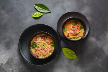 Laksa Soup – a Malaysian Coconut Curry Soup with shrimps over rice noodles topped with fresh bean spouts,cucumber, lime, red chili pepper and cilantro