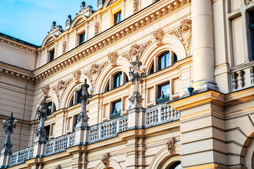 Side view of monumental, rich decored with sculptures and ornaments building of Juliusz Slowacki Theatre in Cracow (Krakow) old town in Poland at dusk