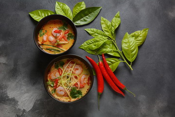 Laksa Soup – a Malaysian Coconut Curry Soup with shrimps over rice noodles topped with fresh bean spouts,cucumber, lime, red chili pepper and cilantro