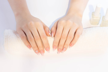 Beautiful soft woman hands with light manicure hand care and spa relaxing