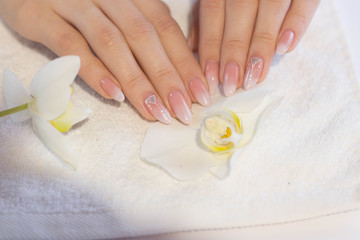 Obraz na płótnie Canvas Beautiful soft woman hands with light manicure hand care and spa relaxing