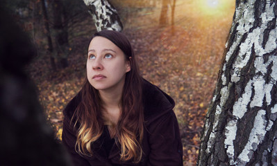 White woman in the forest, autumn, sunset.