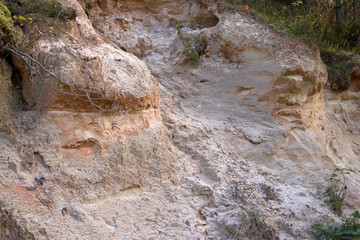Cross section of sandy soil, relief vertical cut closeup, textured background image
