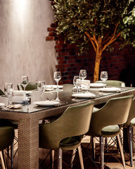 wicker gray table with glass and gray chairs