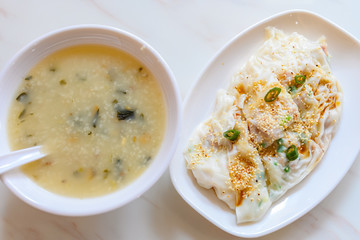 top view traditonal Cantonese food of cheong fun or rice noodle rolls and bowl of porridge