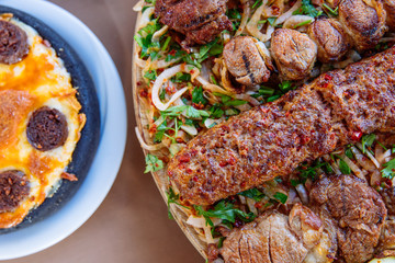 Traditional Turkish Adana kebab or kebap meat food, appetizers, raki and salgam on table from top view in turkish restaurant.	
