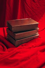close up of vintage golden books on red cloth