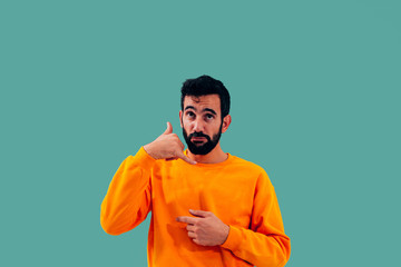 Closeup portrait of a young man - student or worker making call me gesture sign with hand-shaped...