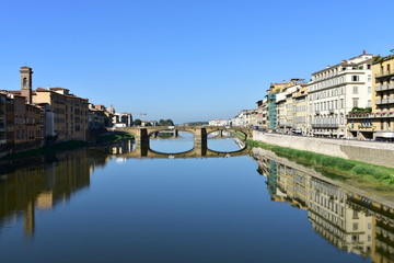 Fototapeta na wymiar View of Arno river with Ponte Santa Trinita from Ponte Vecchio. Florence, Italy. The oldest elliptic arch bridge in the world.