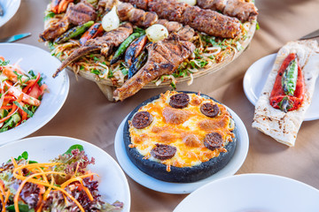 Traditional Turkish Hummus food appetizer with Adana Kebab on table from top view in turkish restaurant.	