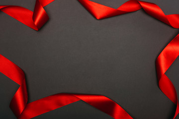 top view of christmas red ribbon on black