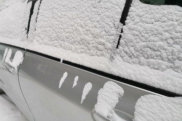 white snow lies on car windows